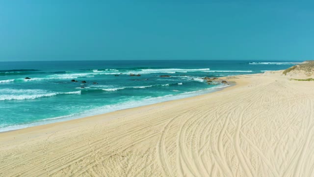 SAN LUIS BEACH EAST CAPE LOS CABOS MEXICO-2021: Gentle Ocean Waves Lapping a Sandy Beach