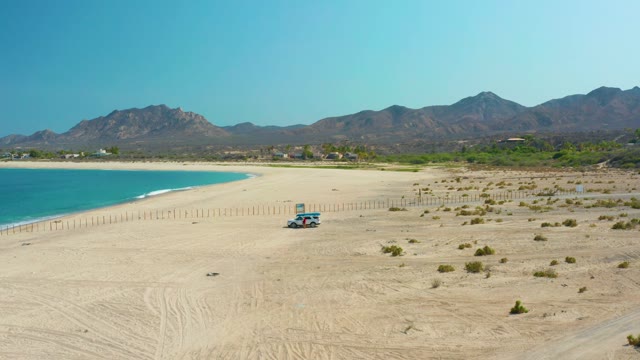 LOS FRALIES LOS CABOS BCS MEXICO-2021: Receding Ocean Waves on Sandy Beach with Vehicle