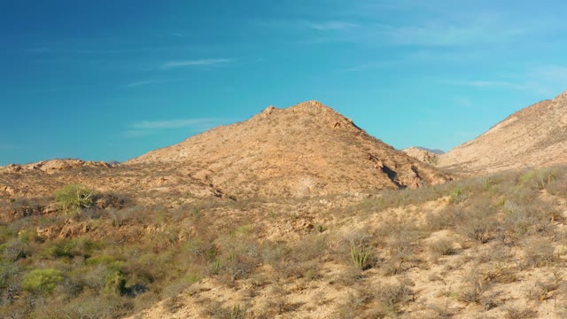 CABO PULMO BCS MEXICO-2021: Arid Desert Terrain with Rocky Mounds and Sparse Vegetation