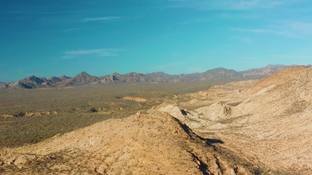 CABO PULMO BCS MEXICO-2021: Desert Hills and Distant Mountain Range Under Clear Sky
