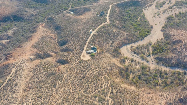 CABO PULMO BCS MEXICO-2021: Vehicle Moving Along Winding Dirt Road in Arid Hills