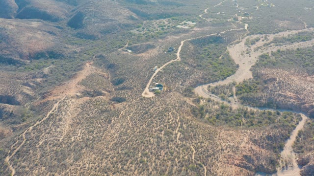 CABO PULMO BCS MEXICO-2021: Vehicle Traveling on Winding Dirt Road Through Arid Hills