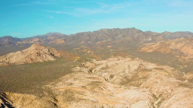 CABO PULMO BCS MEXICO-2021: Vehicle Moving Along Mountain Ridge in Desert