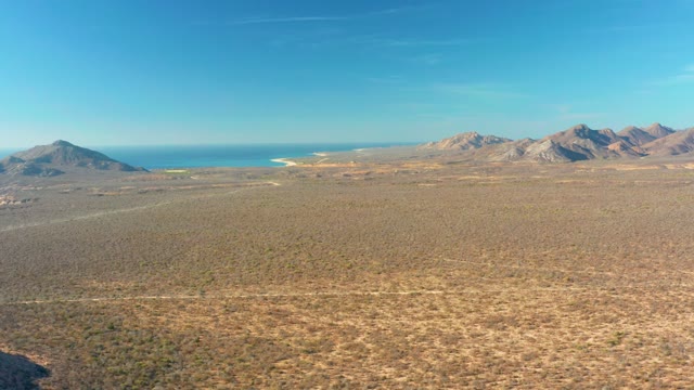 CABO PULMO BCS MEXICO-2021: Moving Shadow over Desert Plain with Mountains and Sea