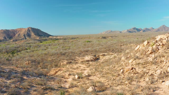 CABO PULMO BCS MEXICO-2021: Slow Pan Across Desert Valley with Distant Mountains