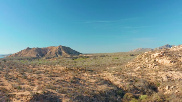 CABO PULMO BCS MEXICO-2021: Desert Landscape Featuring Rocky Hills and Sparse Shrubs