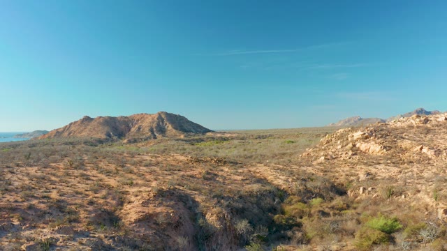CABO PULMO BCS MEXICO-2021: Desert Landscape with Rocky Formations and Sparse Vegetation