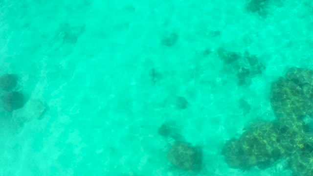 Overhead View of Submerged Rocks in Clear Turquoise Water