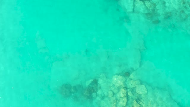 Clear Turquoise Water Flowing Over Rocky Seabed