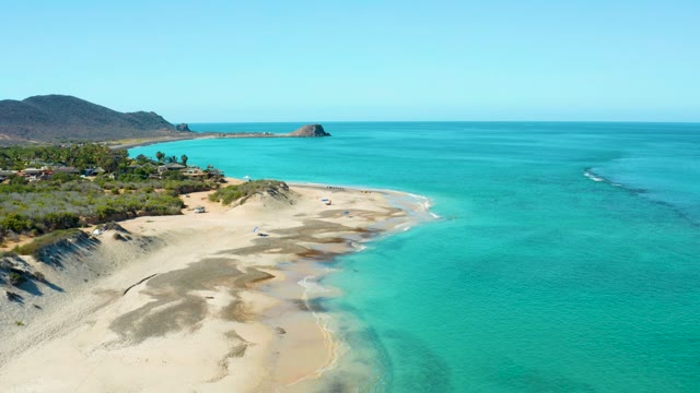Sandy Beach with Turquoise Waters and Dunes