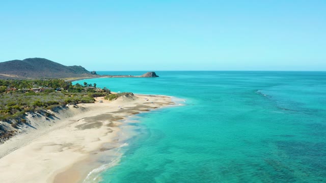 Sandy Shoreline with Clear Turquoise Ocean Waters