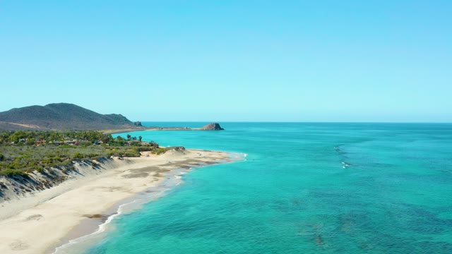 Gentle Waves Lapping Sandy Beach and Turquoise Ocean