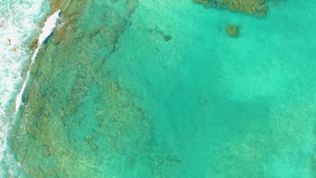 Shoreline Waves and Turquoise Ocean Floor