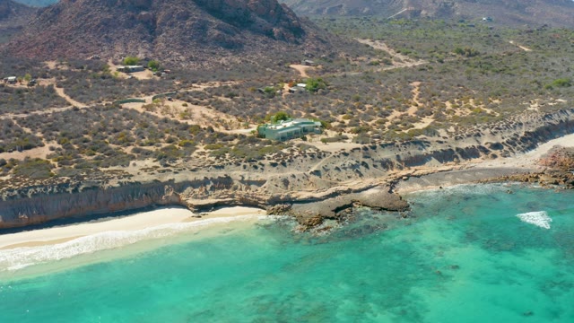 Coastal Cliff with Sandy Beach and Turquoise Water