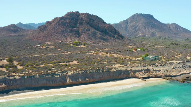 Sandy Beach with Turquoise Water and Mountain Backdrop