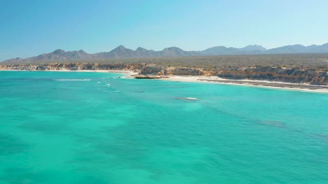 Sandy Beach and Turquoise Ocean with Moving Boats