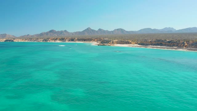 Coastal Waters with Sandy Beach and Mountain Backdrop
