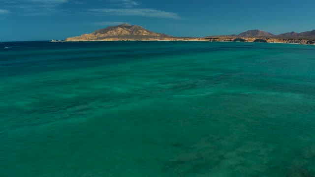 Turquoise Ocean with Distant Shore and Mountains