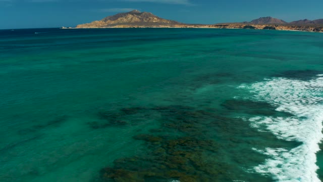 Waves Breaking Over Coral Reef in Turquoise Water
