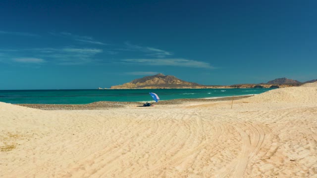 ATV Driving on Sandy Beach with Ocean View