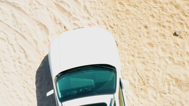 White Car Moving on Sandy Beach