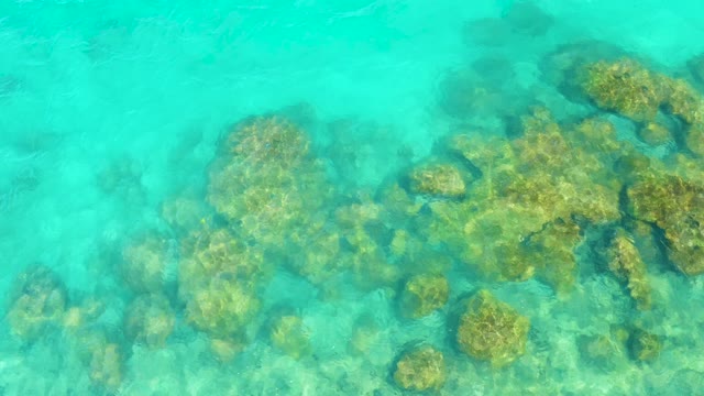 Underwater Rocks Visible Through Clear Turquoise Water