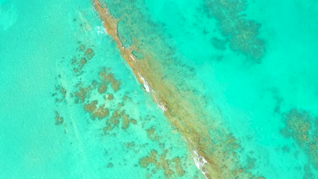 Narrow Sandbar with Gentle Waves in Clear Turquoise Water