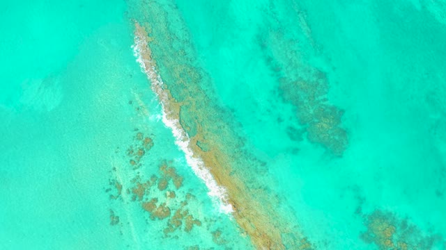 Narrow Sandbar and Gentle Waves in Clear Turquoise Water