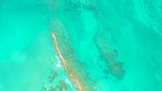 Narrow Sandbar with White Beach in Clear Turquoise Ocean
