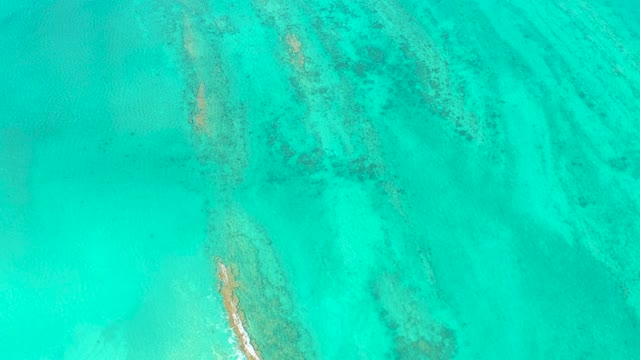 Turquoise Ocean Water Over Coral and Sandy Seabed