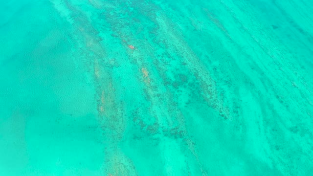 Small Boat Moving Through Clear Turquoise Ocean Waters