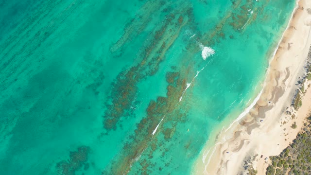 Watercraft Moving Across Turquoise Coastal Waters
