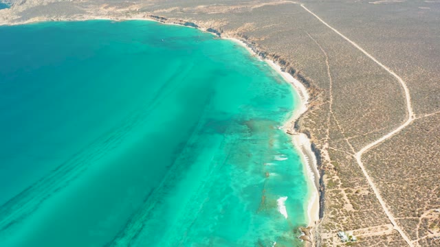 Desert Coastline with Turquoise Ocean and Sandy Beach