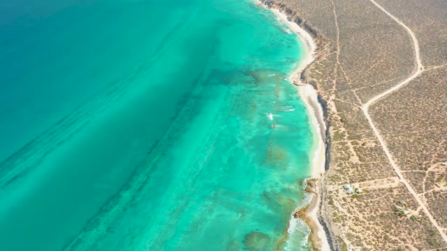 Shoreline with Moving Turquoise Water and Arid Coast