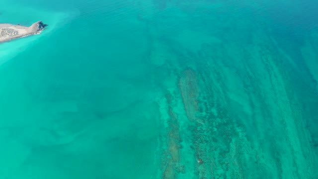 Small Island and Clear Ocean Waters with Visible Seabed