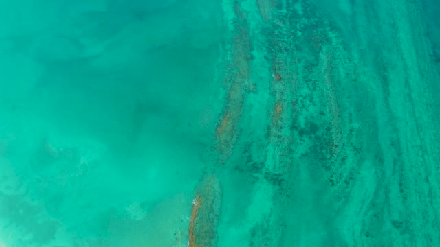 Clear Turquoise Water Over Coral and Sand Patterns