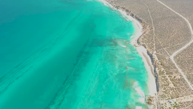 Sandy Beach and Turquoise Ocean Along Desert Coast