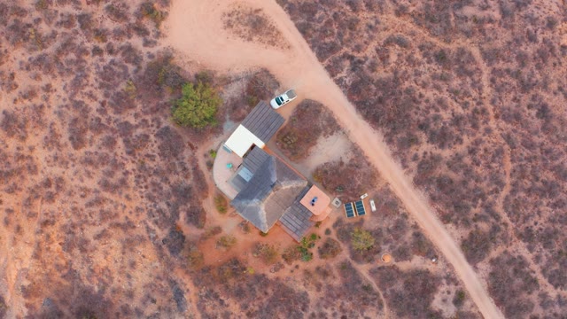 CABO PULMO BCS MEXICO-2021: White Car Drives Past Desert House
