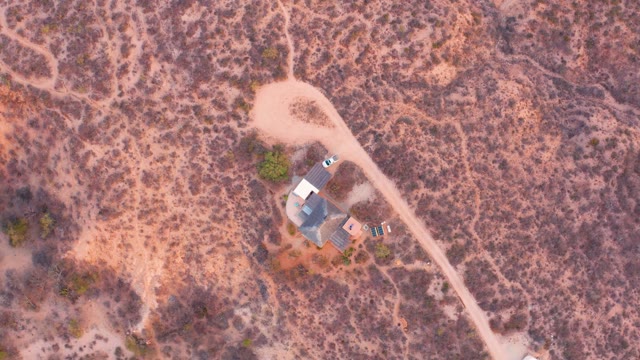 CABO PULMO BCS MEXICO-2021: Car Departing From Desert House on Dirt Road