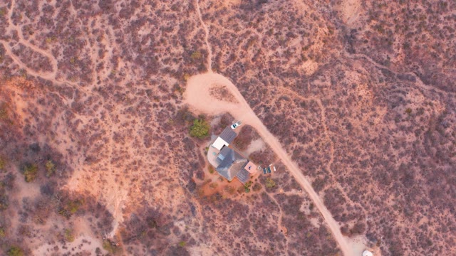 CABO PULMO BCS MEXICO-2021: Vehicle Traveling on Arid Dirt Road Near House