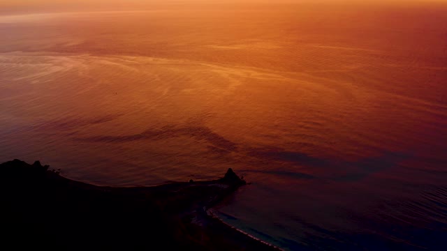 CABO PULMO BCS MEXICO-2021: Sunset over Ocean with Dark Coastline and Pier