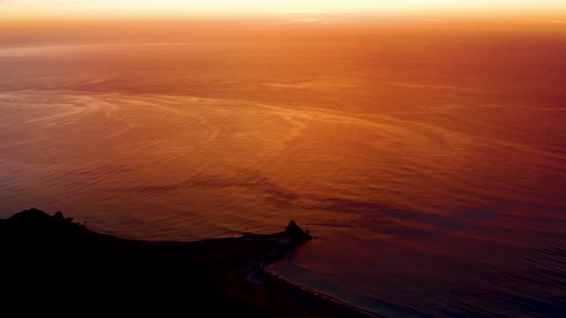 CABO PULMO BCS MEXICO-2021: Sunset Over Ocean with Coastal Silhouette
