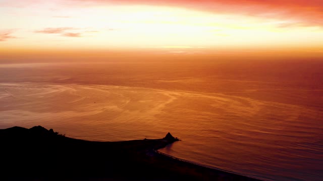 CABO PULMO BCS MEXICO-2021: Sunset over Calm Ocean and Coastal Silhouette