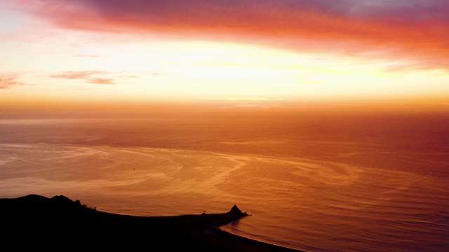 CABO PULMO BCS MEXICO-2021: Sunset over Ocean with Coastal Silhouette