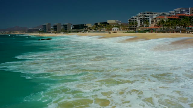 MARQUIS LOS CABOS BCS MEXICO-2021: Waves Rolling Onto Sandy Beach with Coastal Buildings
