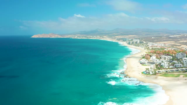 MARQUIS LOS CABOS BCS MEXICO-2021: Ocean Waves Crashing on Sandy Beach with Coastal Buildings