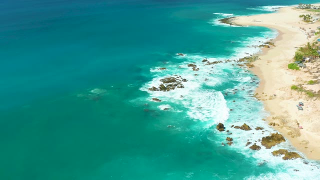 MARQUIS LOS CABOS BCS MEXICO-2021: Waves Crashing Against Rocky Beach With Turquoise Ocean