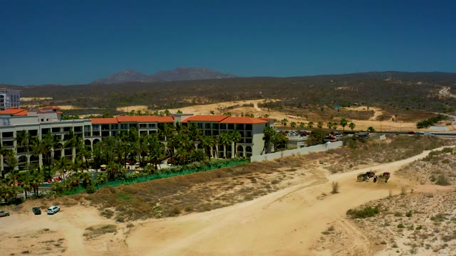 DREAMS LOS CABOS BCS MEXICO-2021: Red-Roofed Building and Palm Trees in Arid Landscape