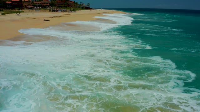 DREAMS LOS CABOS BCS MEXICO-2021: Waves Advancing and Receding on Sandy Beach