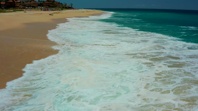 DREAMS LOS CABOS BCS MEXICO-2021: Waves Rolling Onto Sandy Beach Shoreline
